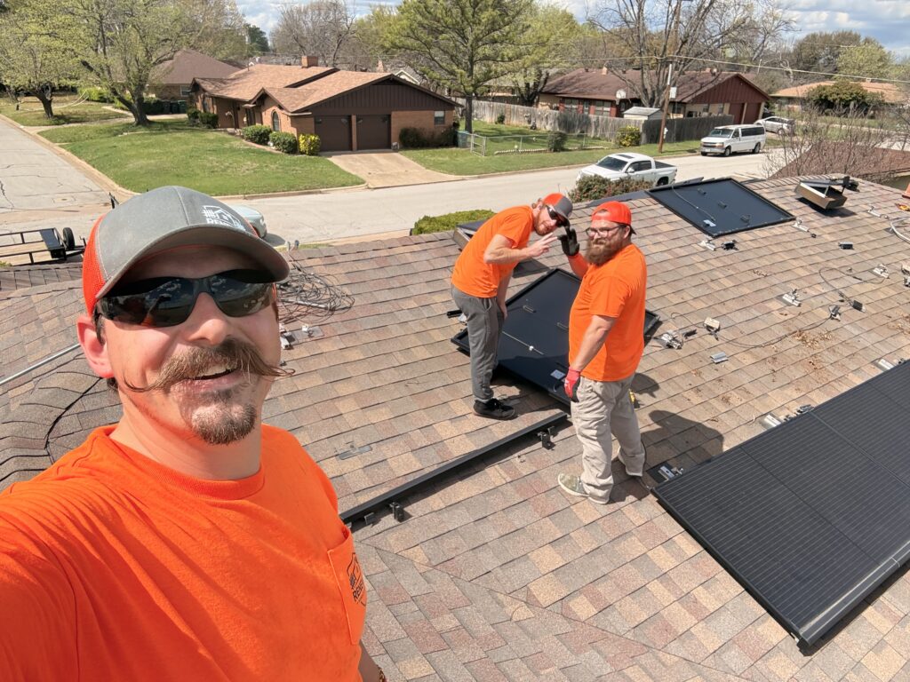 The Renewal Home Exteriors Team working on the roof of a home